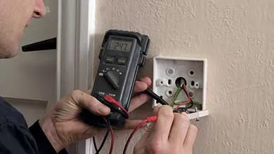 male working on interior electrical box